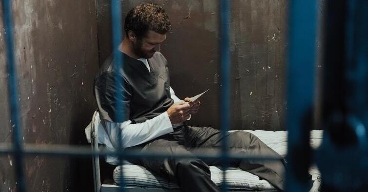 inmate reading in a cell